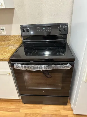 a stove top oven sitting inside of a kitchen