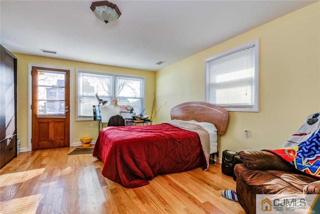 106 Rector Street Perth Amboy, NJ 08861 - Photo 15 of 20 a bedroom with two beds and a window