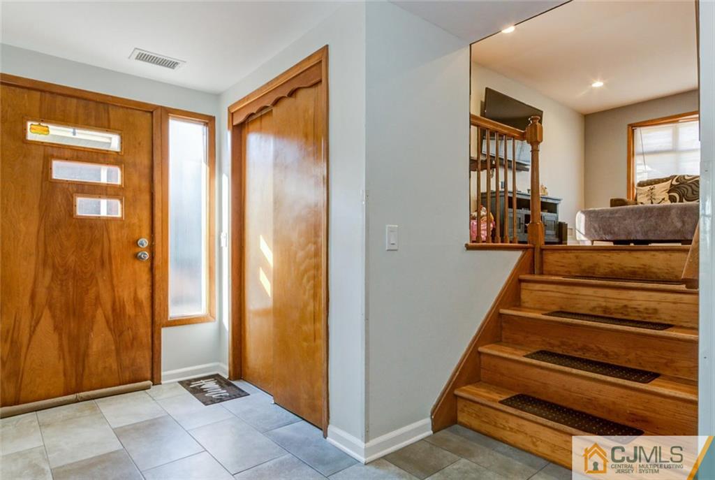 106 Rector Street Perth Amboy, NJ 08861 - Photo 16 of 20 a view of an entryway with wooden floor and windows