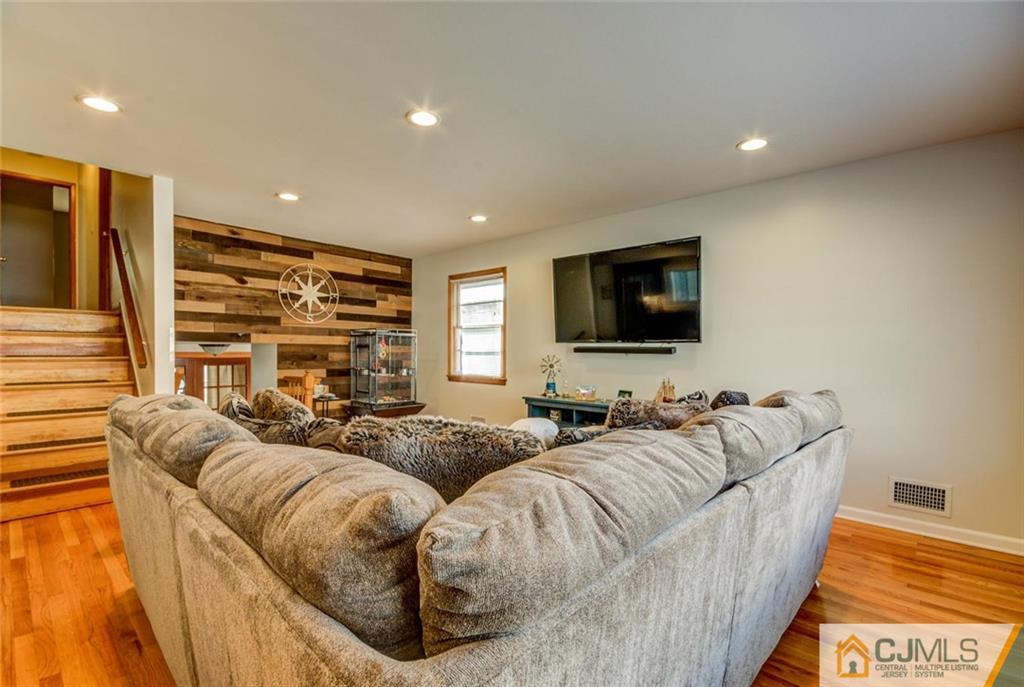 106 Rector Street Perth Amboy, NJ 08861 - Photo 6 of 20 a living room with furniture and a flat screen tv