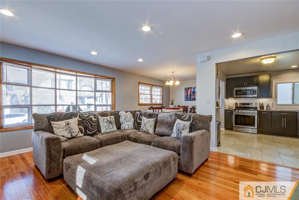 106 Rector Street Perth Amboy, NJ 08861 - Photo 7 of 20 a living room with furniture and kitchen view with wooden floor