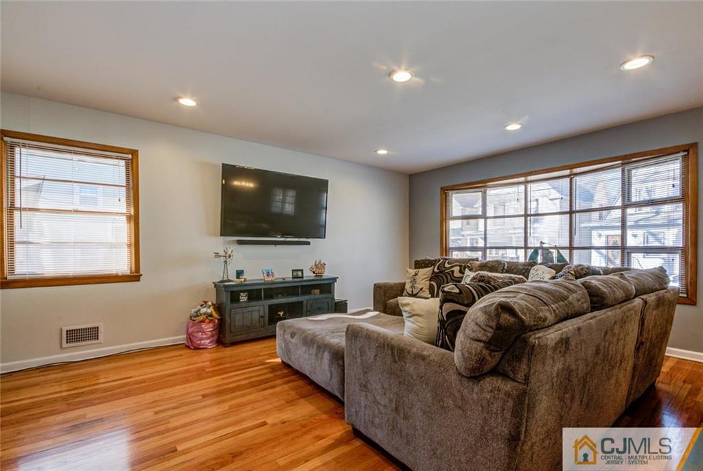106 Rector Street Perth Amboy, NJ 08861 - Photo 8 of 20 a living room with furniture and a flat screen tv