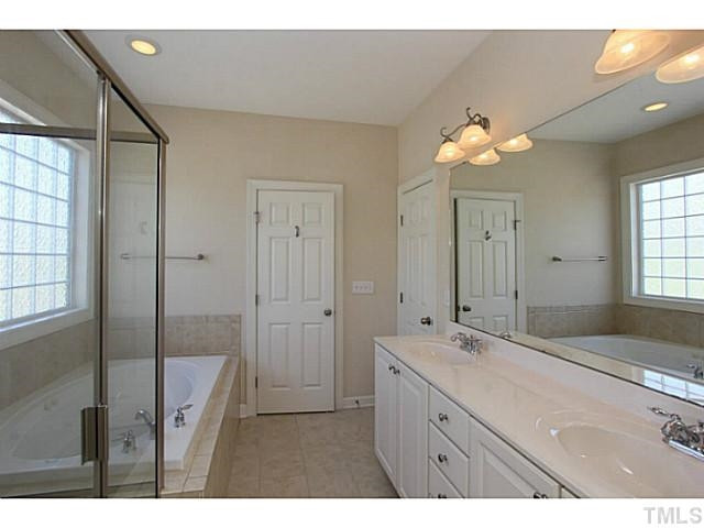 4701 All Points View Way Raleigh, NC 27614 - Photo 12 of 20 Spacious Master Bath features dual sink with large vanity which provides plenty of storage and counter-top space, separate shower, garden tub and large glass block window provides plenty of natural light. Master Bath