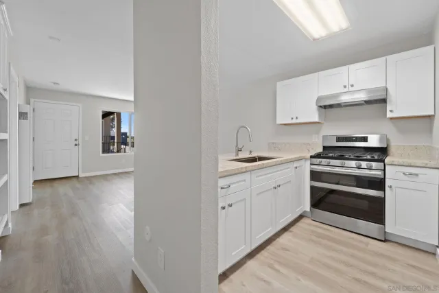 a kitchen with stainless steel appliances granite countertop a stove and a sink