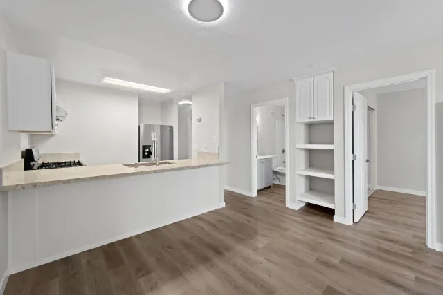 a view of kitchen with wooden floor and electronic appliances