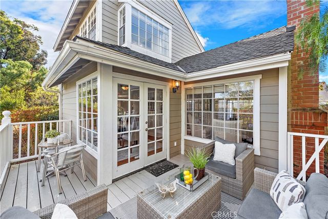a view of a patio with a table and chairs and a barbeque