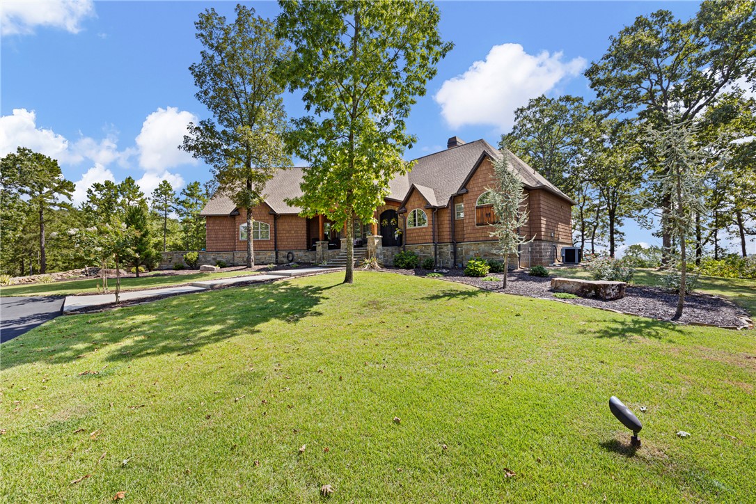 Wood-sided residence with a shingle roof and a stone foundation