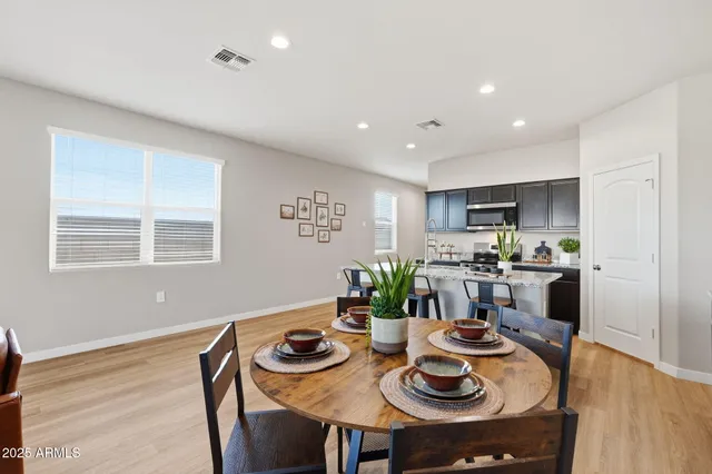 a kitchen with a dining table and chairs