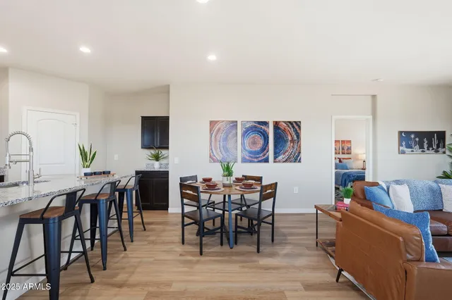 a view of a dining room with furniture and chandelier