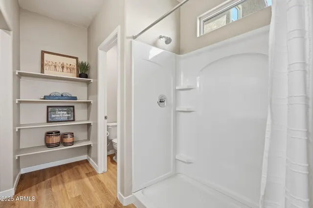 a bathroom with a granite countertop sink a mirror and a bathtub