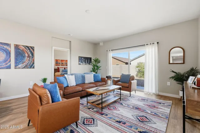 a living room with furniture a rug and a window