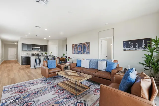a living room with furniture and kitchen view