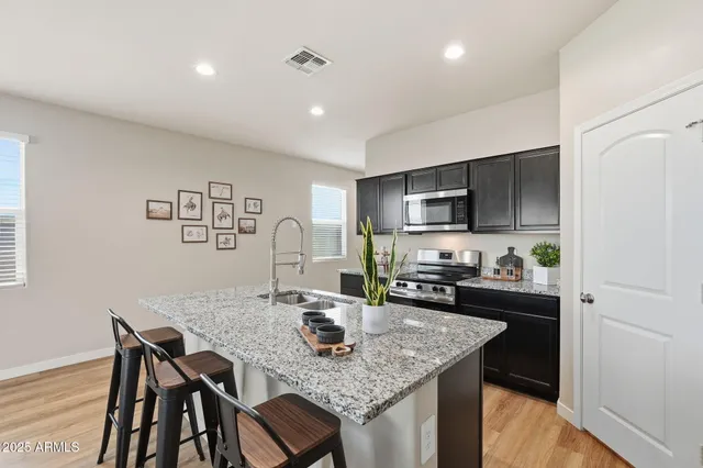 a kitchen with a table chairs and microwave