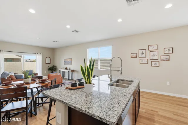 a dining room with furniture and potted plant