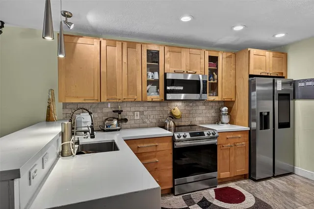 a kitchen with a sink a stove and refrigerator