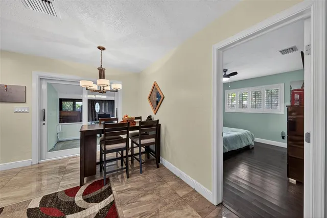 a view of a livingroom with furniture wooden floor a chandelier