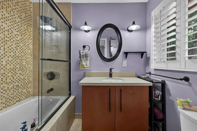 a bathroom with a granite countertop sink a toilet and a bathtub