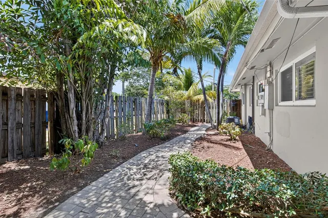 a front view of a house with a garden and patio