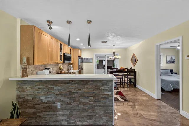 a view of a living room and kitchen