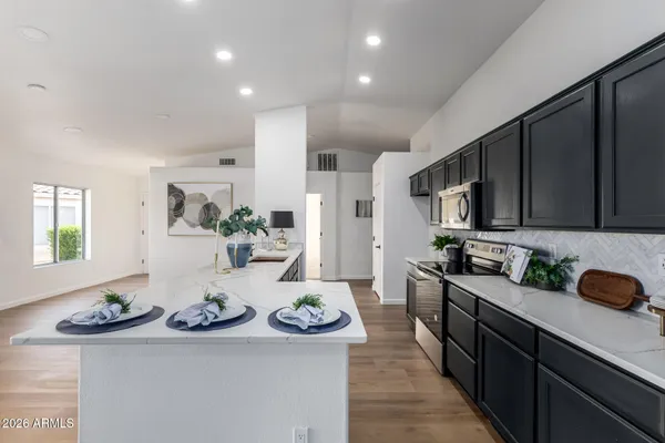 a kitchen with sink refrigerator and stove