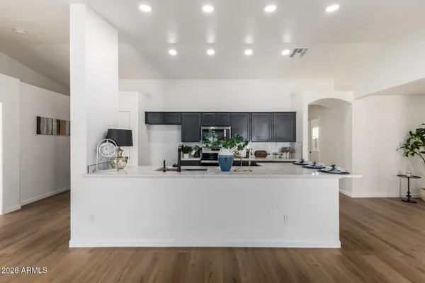 a kitchen with stainless steel appliances a refrigerator a stove a sink and a microwave