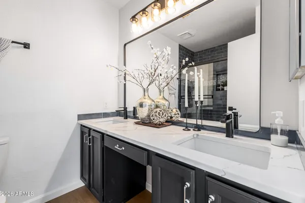 a bathroom with a granite countertop sink toilet and shower