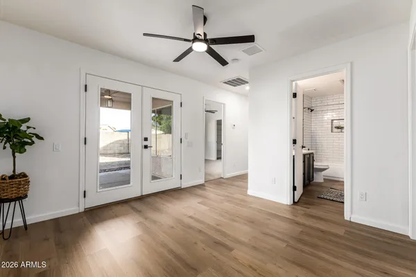 a view of a hallway with wooden floor