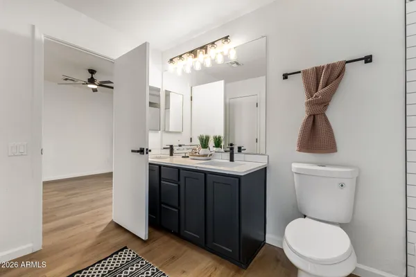 a bathroom with a double vanity sink toilet and shower