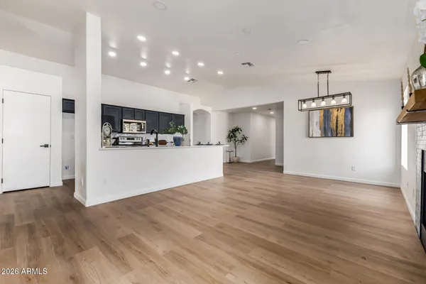 a view of a kitchen with a sink and a refrigerator