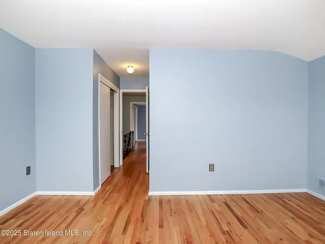 a view of a big room with wooden floor and staircase
