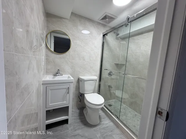 a bathroom with a toilet sink and a shower