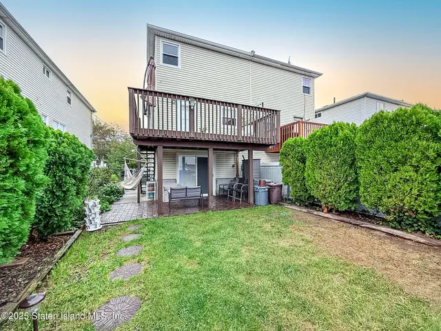 a backyard of a house with a fire pit and outdoor seating