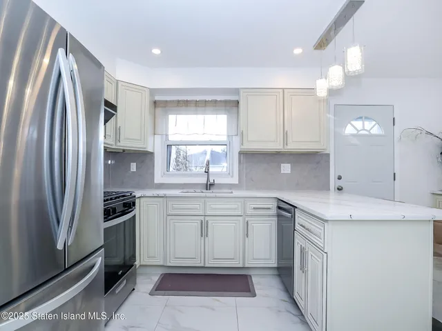 a kitchen with a sink stove and refrigerator