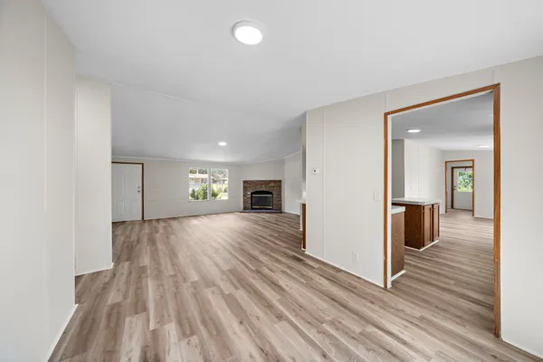 wooden floor in an empty room and a fireplace