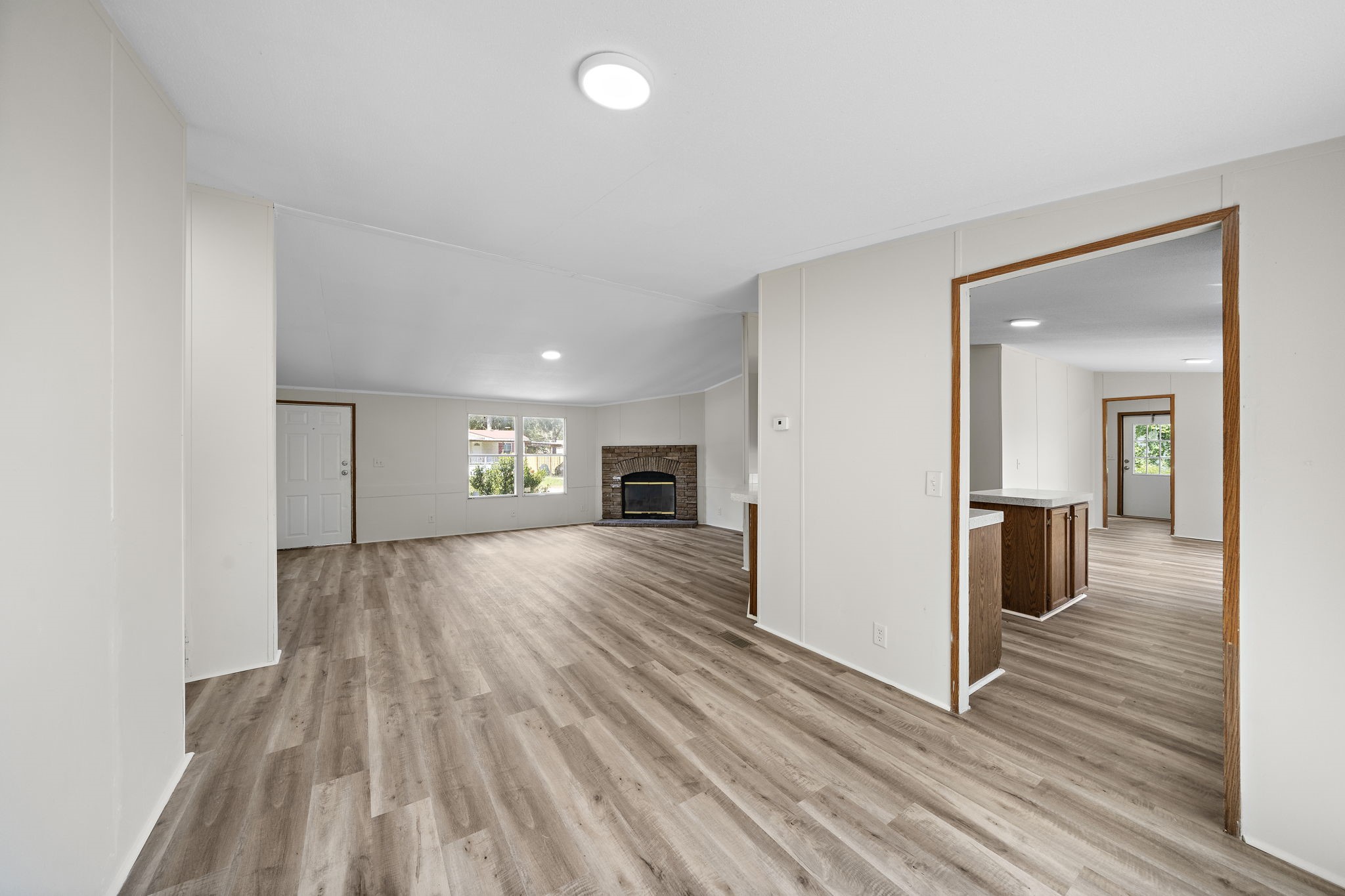 16482 Pisces Road Conroe, TX 77306 - Photo 11 of 35 wooden floor in an empty room and a fireplace