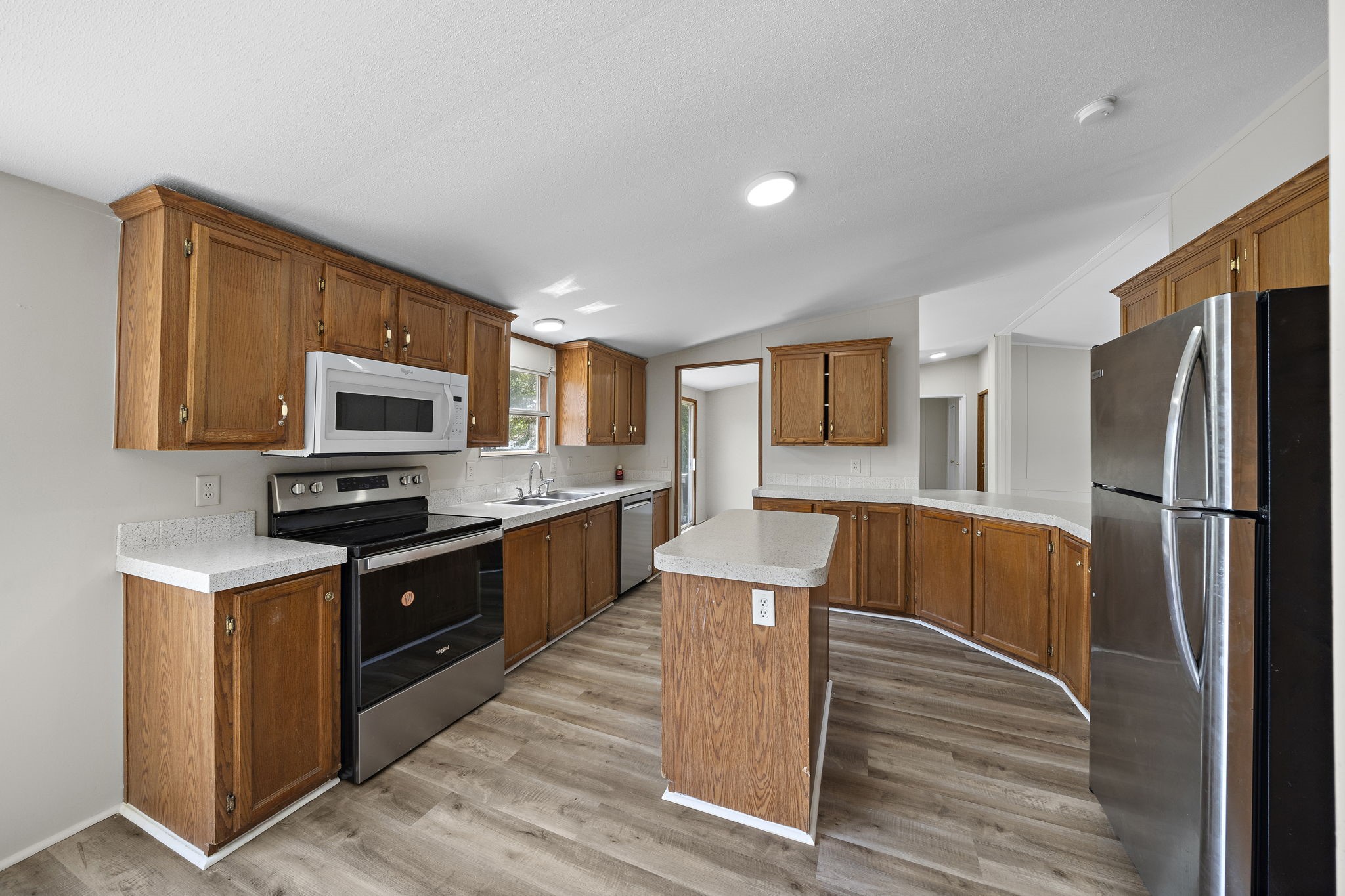 16482 Pisces Road Conroe, TX 77306 - Photo 14 of 35 a kitchen with stainless steel appliances granite countertop a refrigerator stove microwave and sink