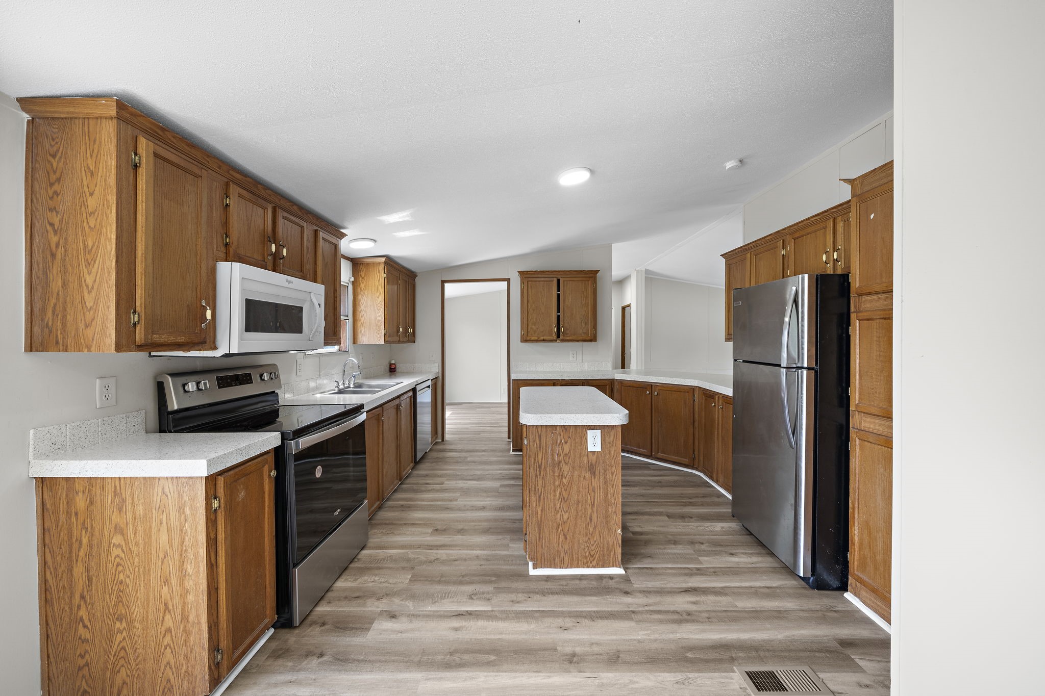 16482 Pisces Road Conroe, TX 77306 - Photo 15 of 35 a kitchen with stainless steel appliances granite countertop a refrigerator a stove top oven and a sink