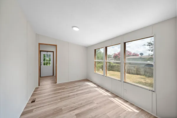 a view of wooden floor and windows in a room