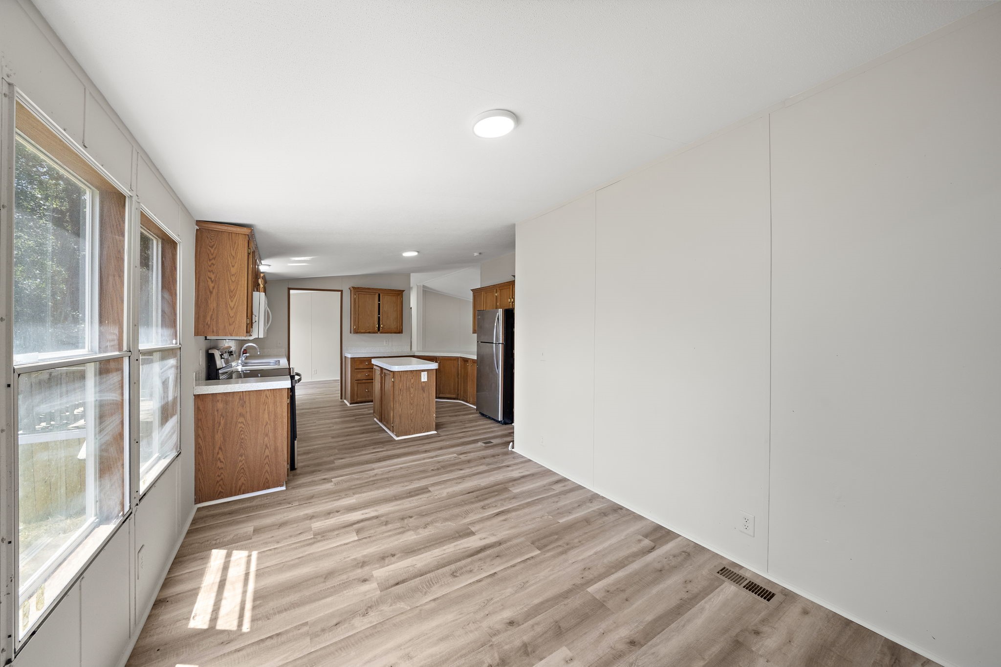 16482 Pisces Road Conroe, TX 77306 - Photo 17 of 35 a view of a kitchen with furniture and wooden floor