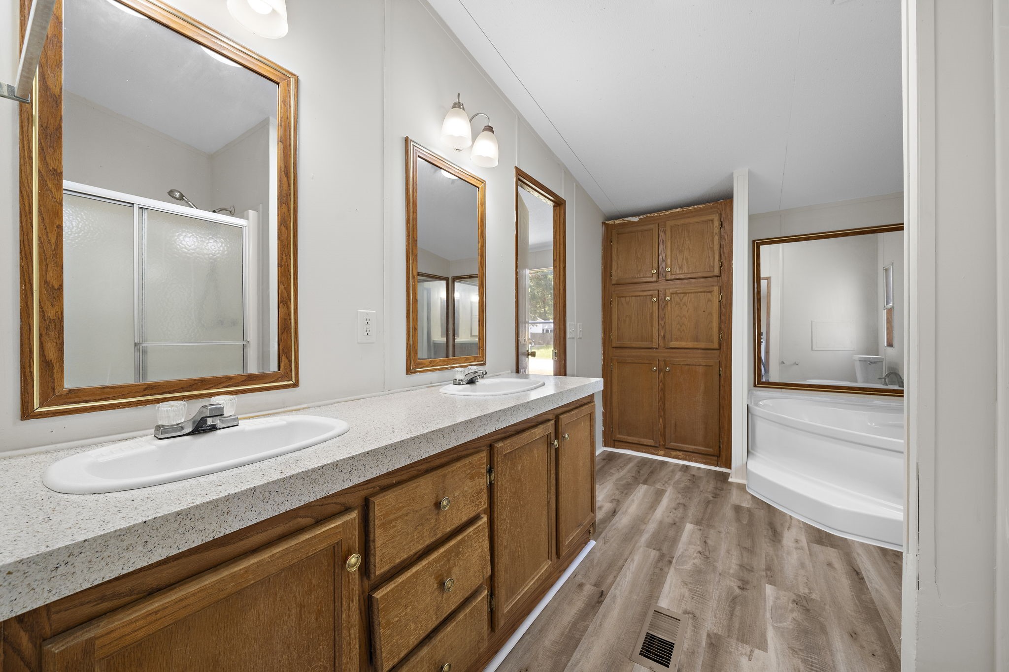 16482 Pisces Road Conroe, TX 77306 - Photo 19 of 35 a bathroom with a double vanity sink a mirror and a shower