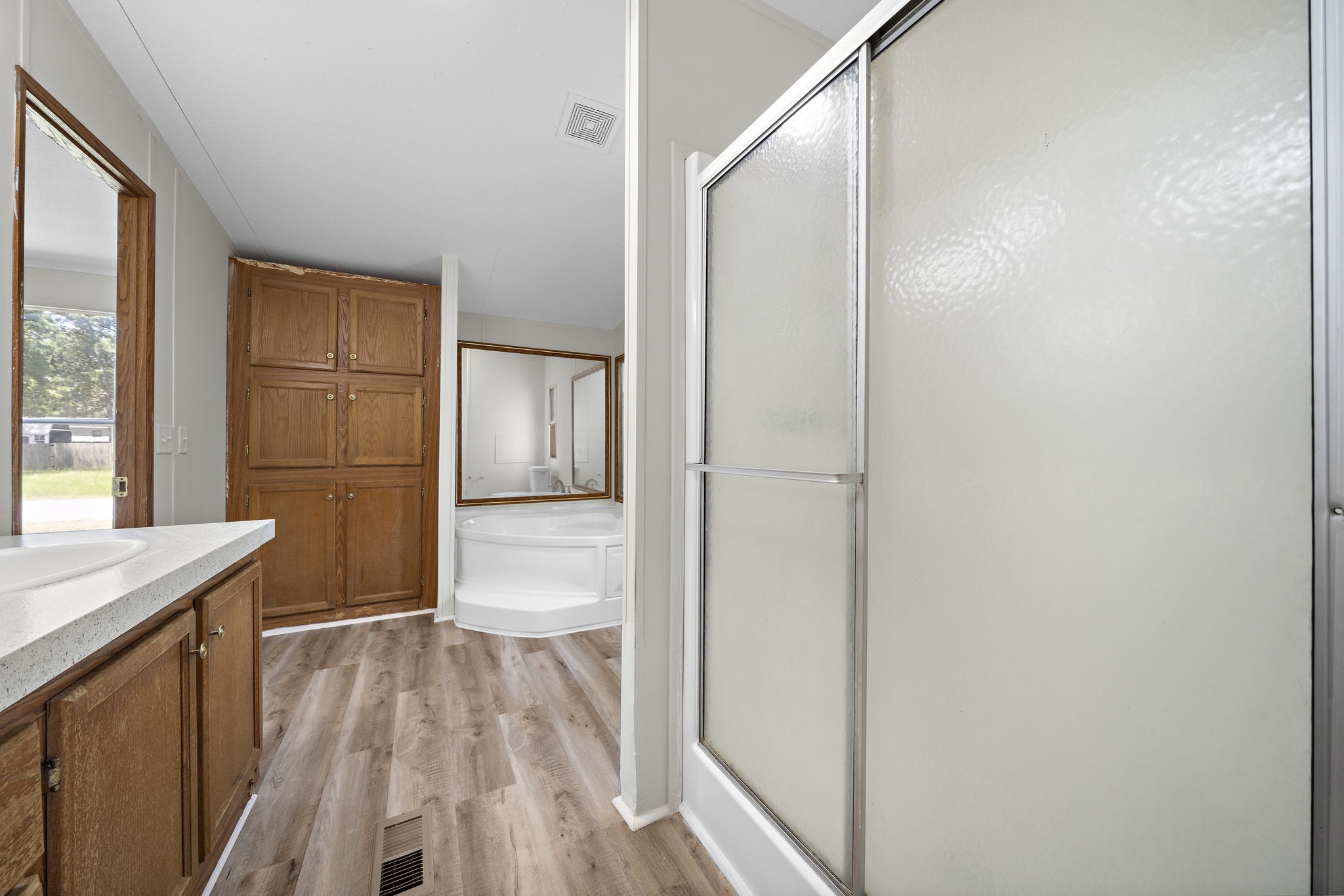 16482 Pisces Road Conroe, TX 77306 - Photo 22 of 35 a bathroom with a sink and a large mirror