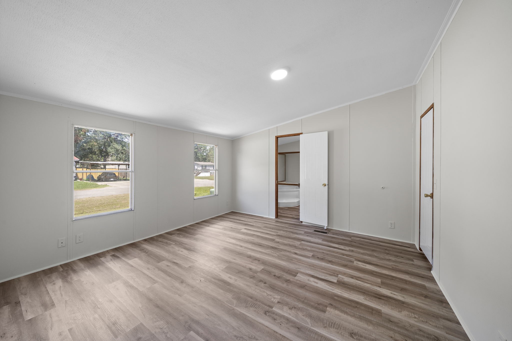 16482 Pisces Road Conroe, TX 77306 - Photo 25 of 35 a view of an empty room with wooden floor and a window