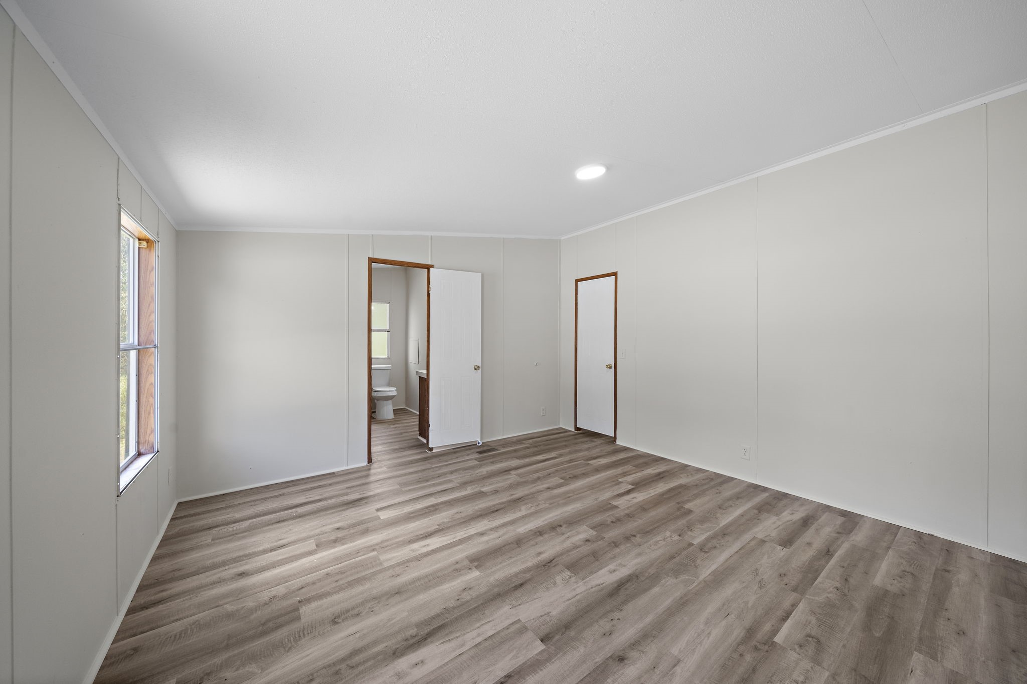 16482 Pisces Road Conroe, TX 77306 - Photo 26 of 35 a view of an empty room with wooden floor