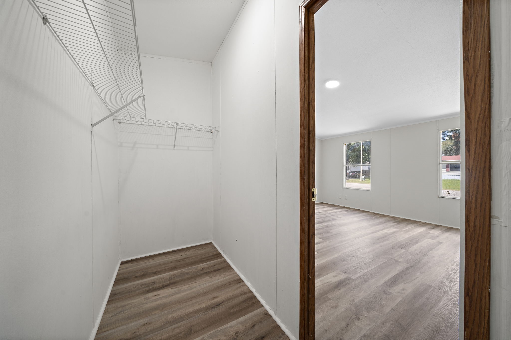 16482 Pisces Road Conroe, TX 77306 - Photo 27 of 35 a view of a hallway with wooden floor and cabinet