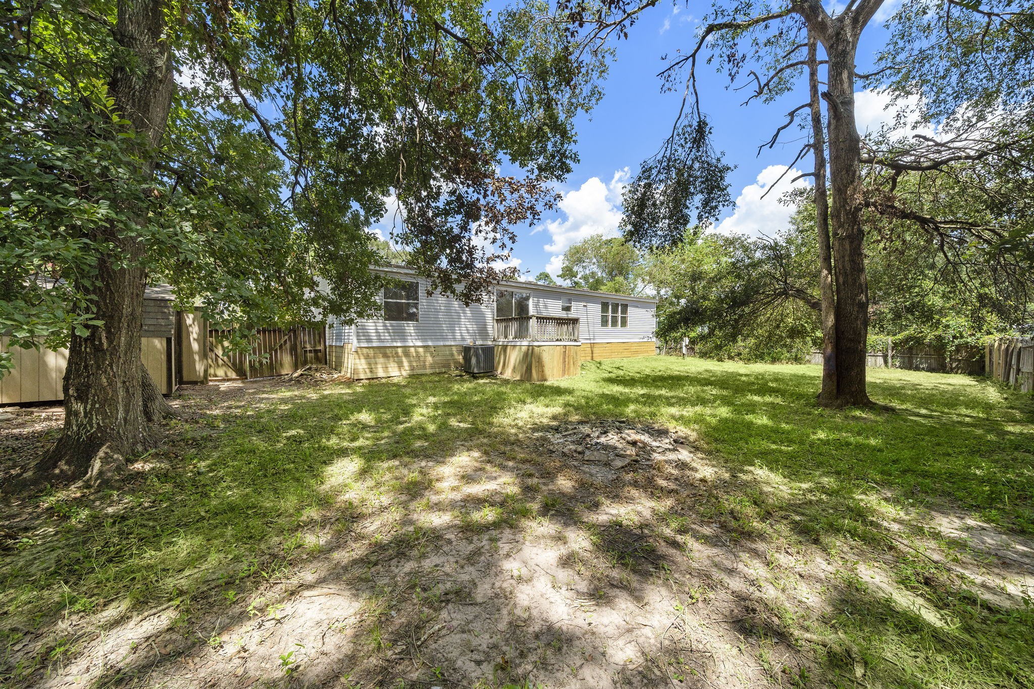 16482 Pisces Road Conroe, TX 77306 - Photo 34 of 35 a view of a yard with plants and a large tree