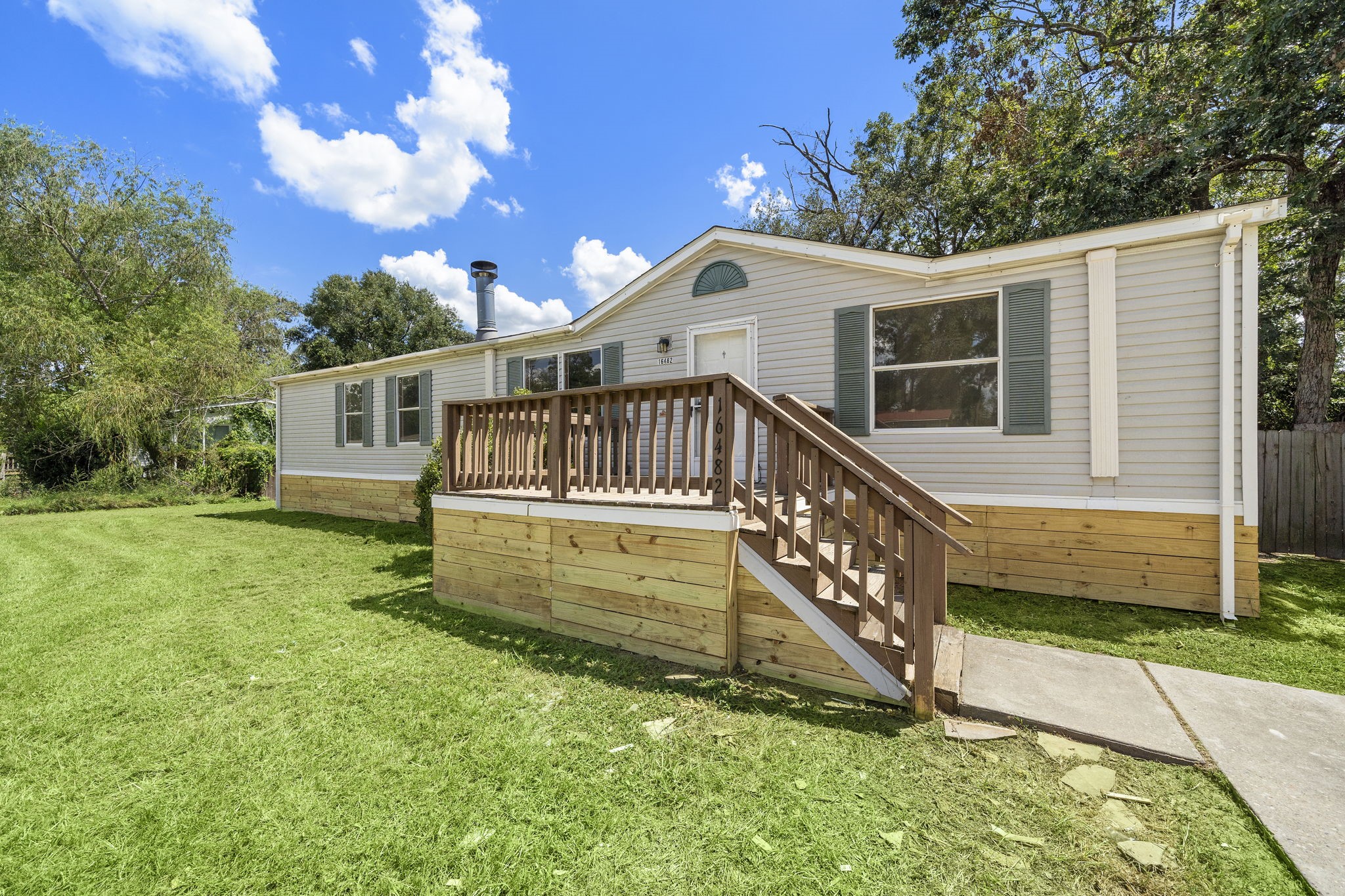 16482 Pisces Road Conroe, TX 77306 - Photo 4 of 35 a view of a house with a yard