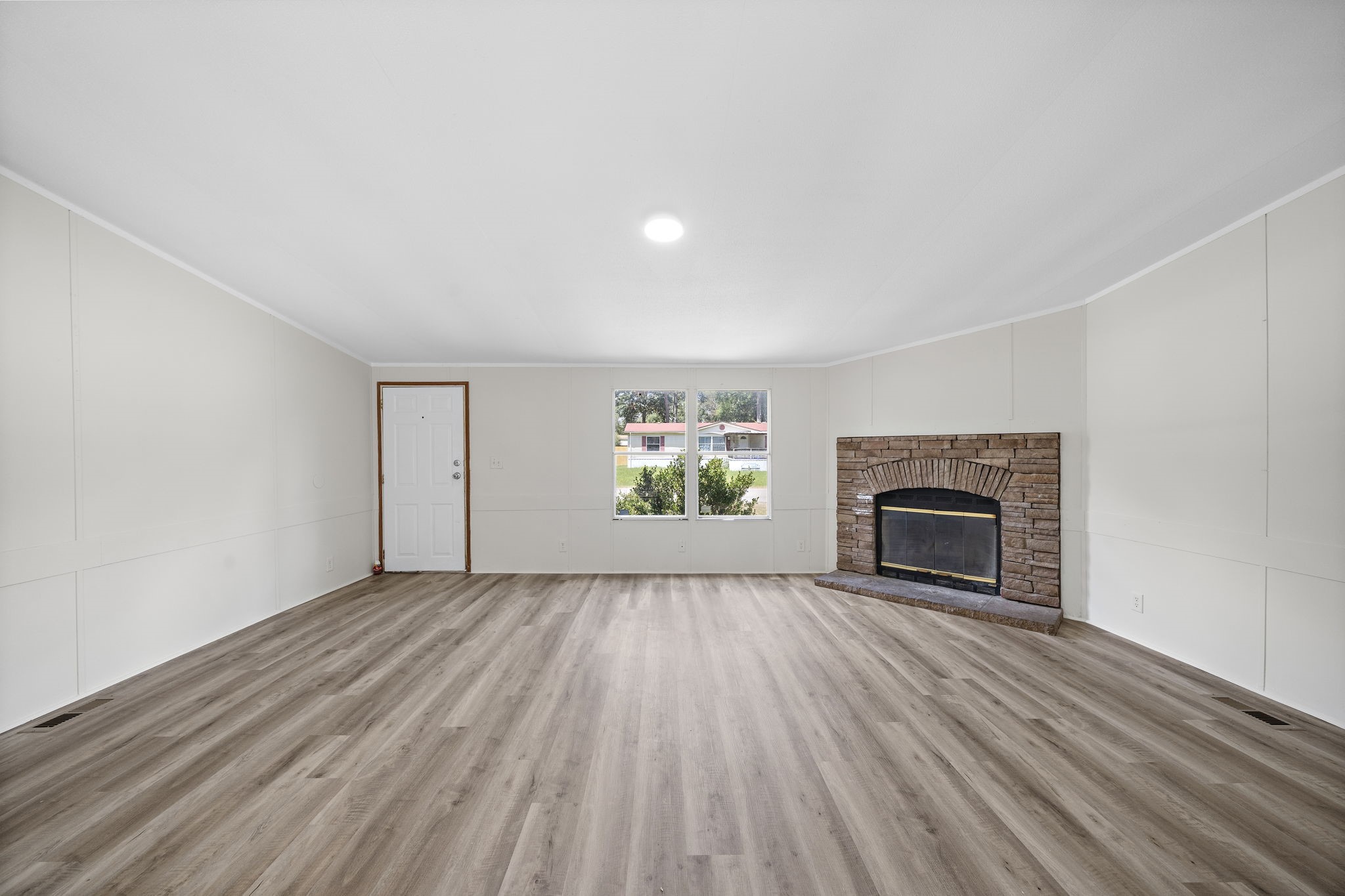 16482 Pisces Road Conroe, TX 77306 - Photo 5 of 35 a view of empty room with wooden floor and fireplace