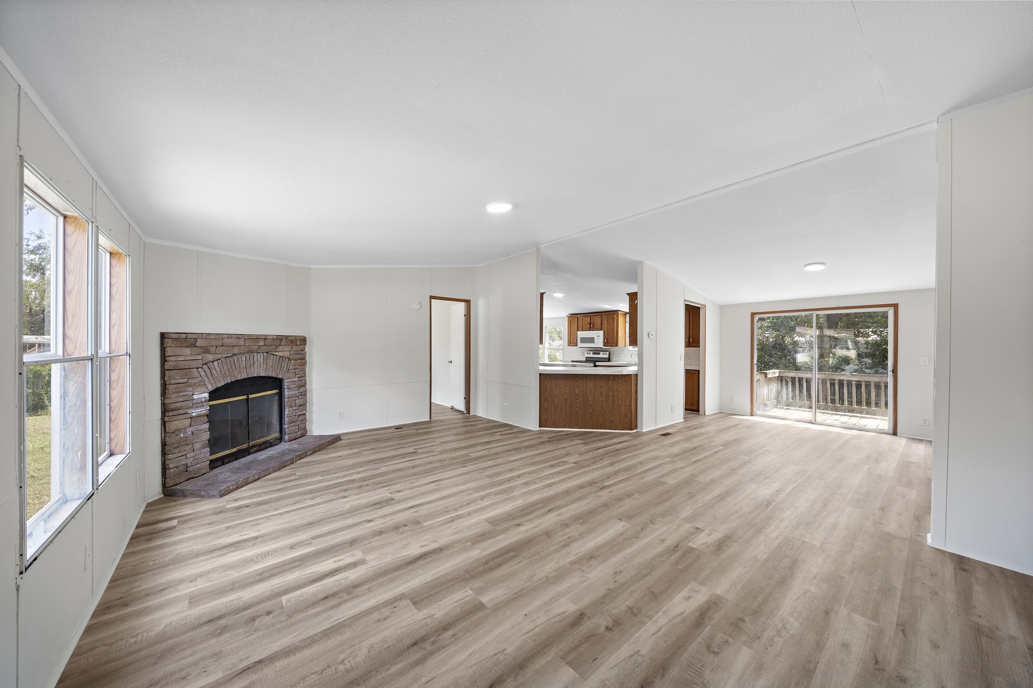 16482 Pisces Road Conroe, TX 77306 - Photo 7 of 35 a view of a livingroom with wooden floor and a fireplace