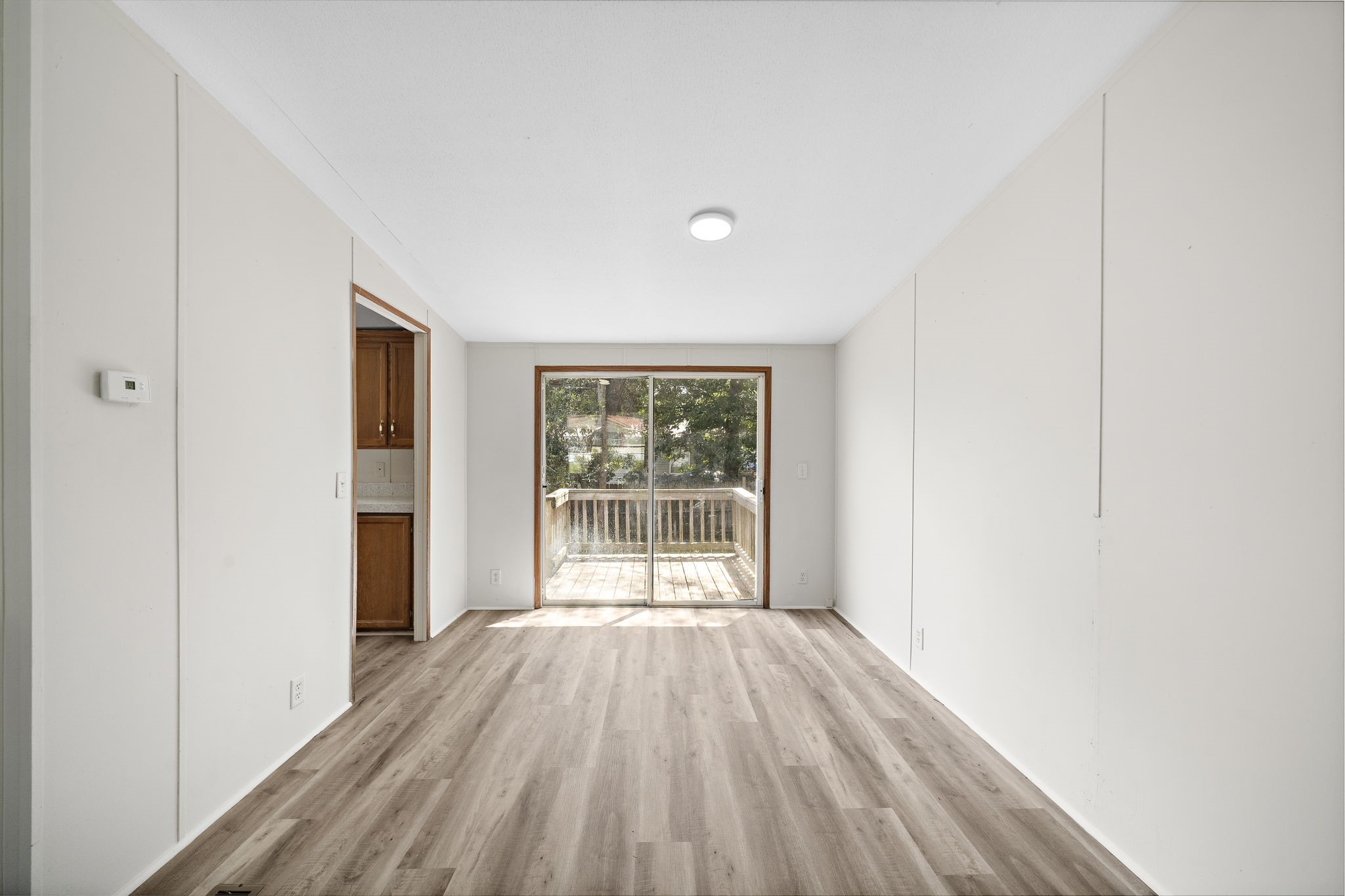16482 Pisces Road Conroe, TX 77306 - Photo 8 of 35 a view of a room with wooden floor and windows