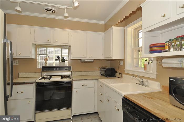 1807 Myrtle Road Silver Spring, MD 20902 - Photo 14 of 27 a kitchen with a sink stove top oven and cabinets